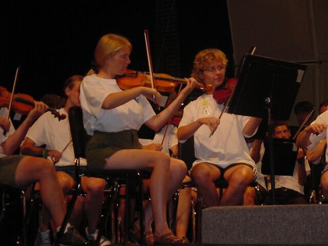 Violins Section, some with sunburned legs